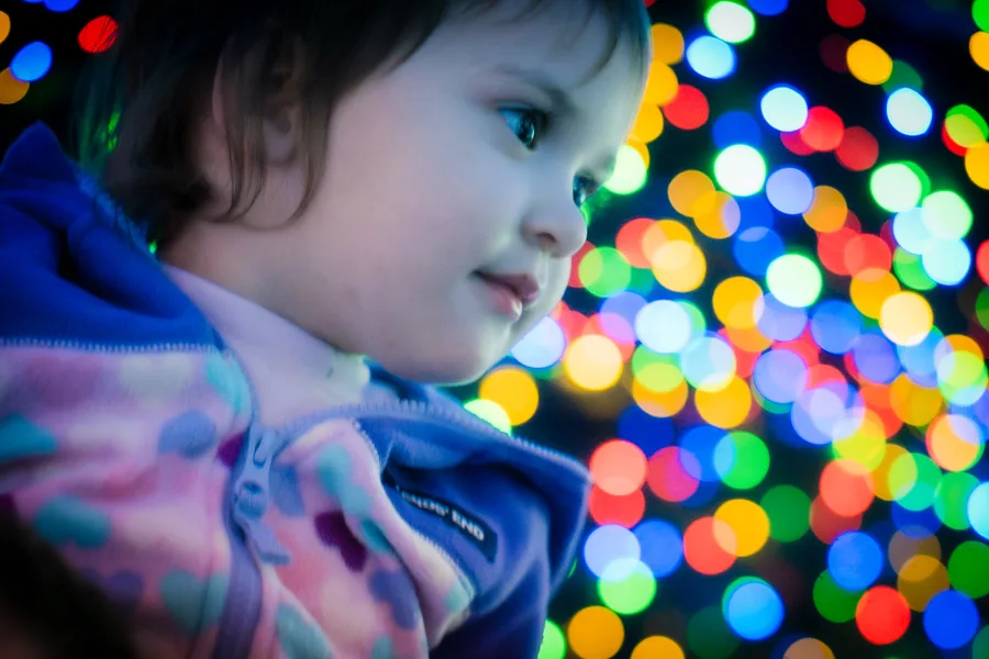 Child at Christmas lights — candid event photography Austin TX